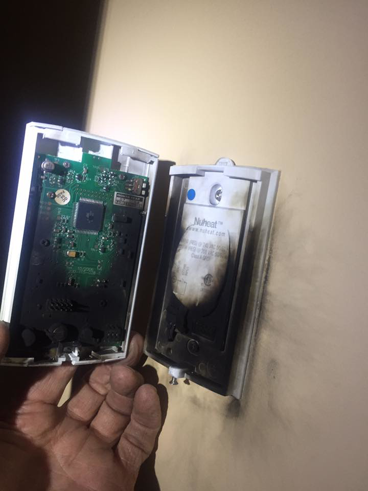 A burnt electrical thermostat or control unit being inspected by William Lego Electrical Services in Rockford, IL