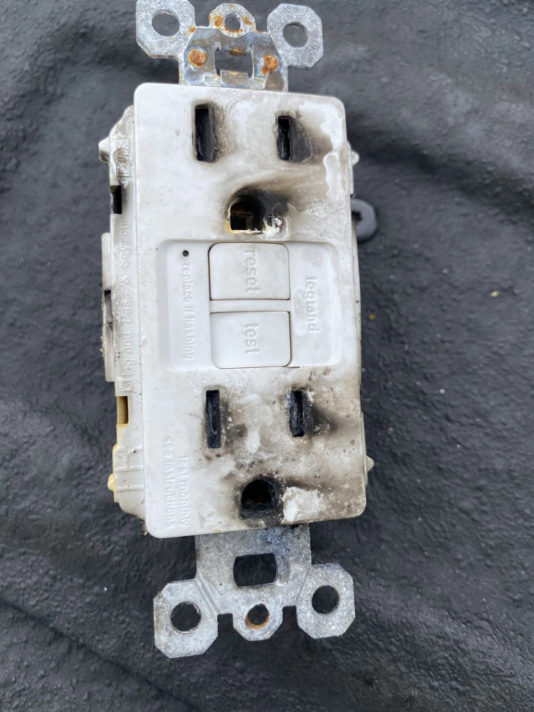 A burnt GFCI outlet requiring replacement by Southern Electrical Services, LLC in Leesburg, VA.