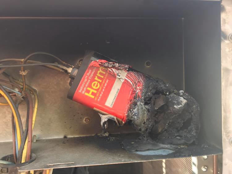 A burnt-out HVAC capacitor requiring repair, serviced by Bergmann Heating & Air Conditioning, LLC in Orem, UT
