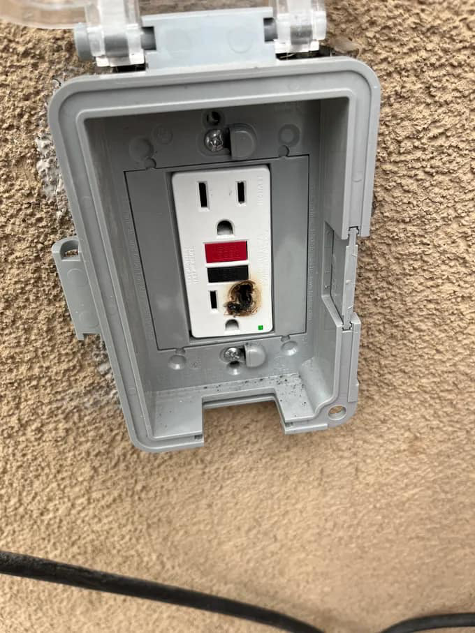 A burnt outdoor electrical outlet requiring repair from Bonafide Electrical Services in Denham Springs, LA.
