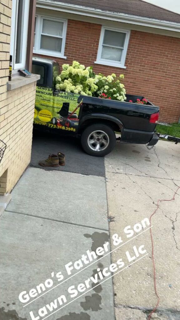 A business truck filled with plants and flowers for a landscaping job by Geno's Father & Son Lawn Services Llc in Hammond, IN