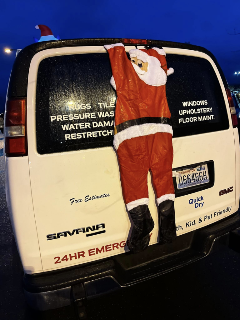 The back of a Mountain View Carpet Care LLC business van in Vancouver, WA, listing services like rugs, tile, water damage, and upholstery cleaning.