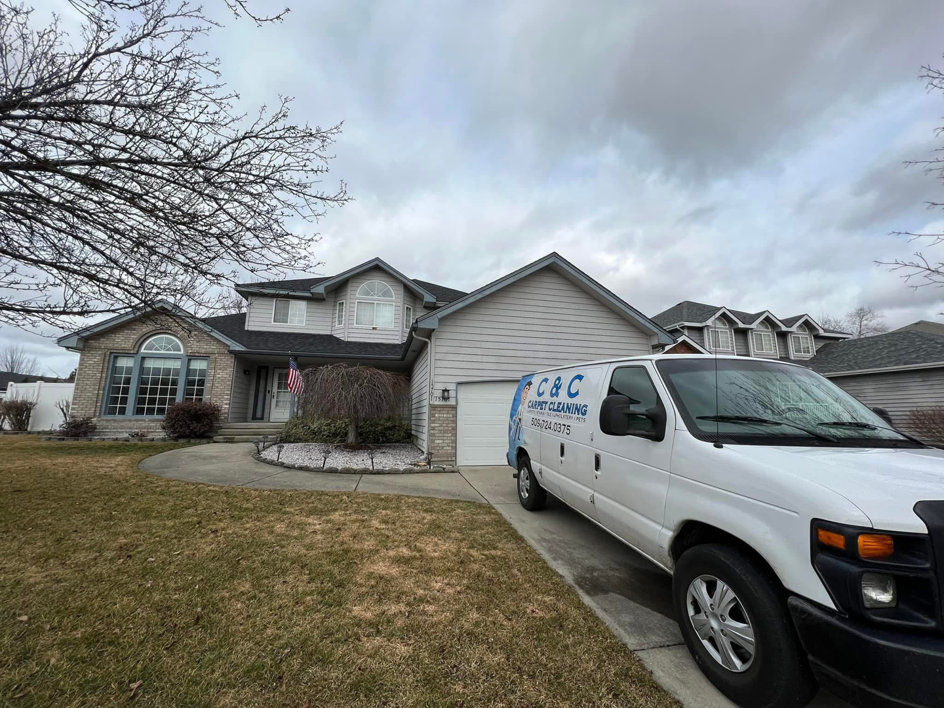 The C & C Carpet Cleaning service van parked in front of a residential home for a job in Spokane, WA.