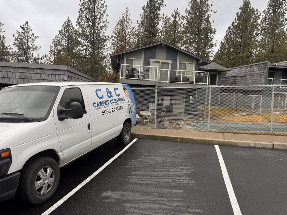 The C & C Carpet Cleaning service van parked outside a client's building in Spokane, WA, ready for a job.