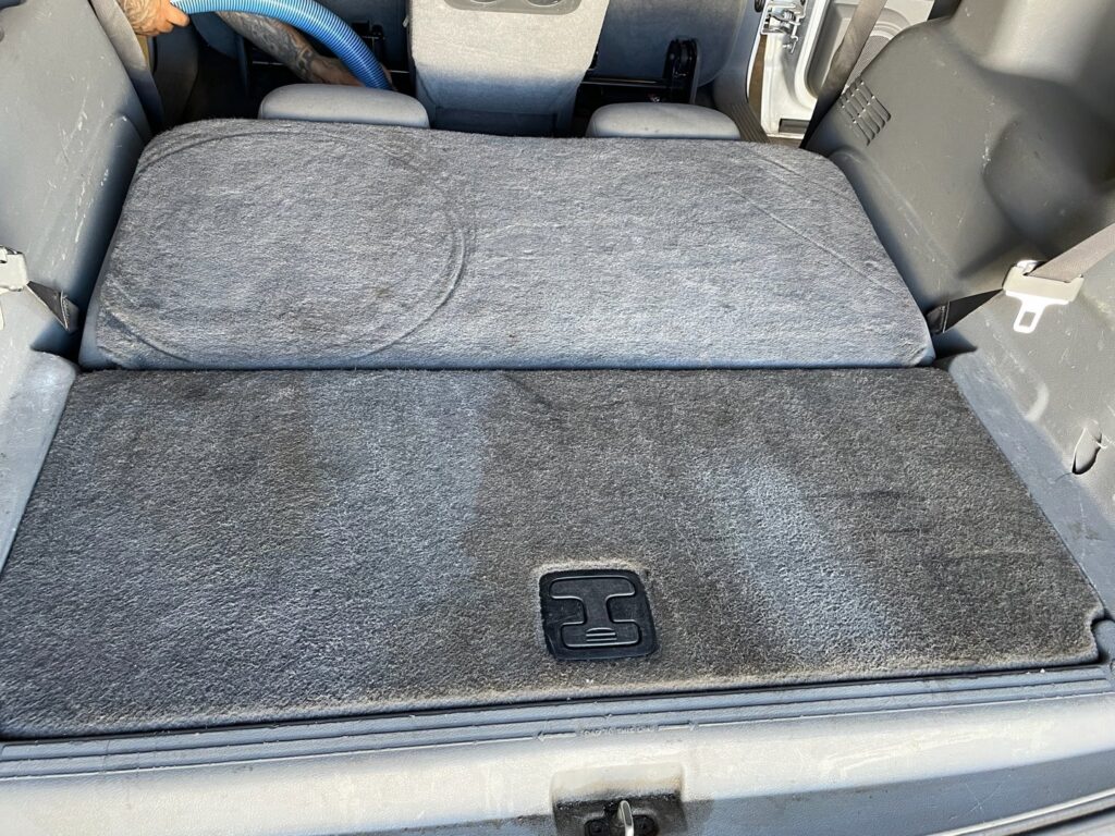 Professional cleaning of a car's interior carpet in the trunk area by Steamway Carpet Cleaning in El Paso, TX