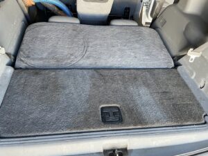 Professional cleaning of a car's interior carpet in the trunk area by Steamway Carpet Cleaning in El Paso, TX