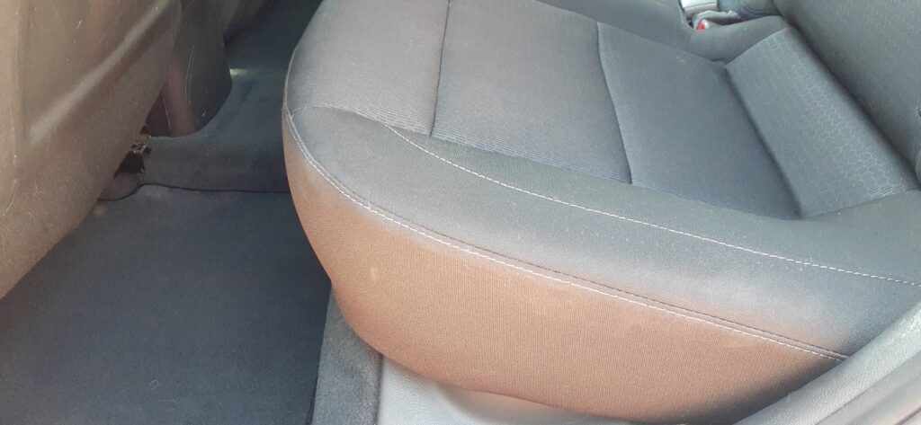 A car seat and floor mats showing dirt before auto upholstery cleaning by El Paso Carpet Care in El Paso, TX.