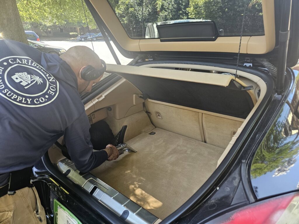 A professional cleaning the carpeted trunk of a car by Right & Clean Atlanta 24-7 Carpet Cleaning in Atlanta, GA.