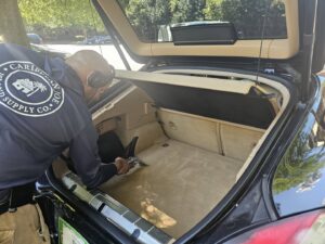 A professional cleaning the carpeted trunk of a car by Right & Clean Atlanta 24-7 Carpet Cleaning in Atlanta, GA.