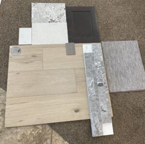 Various flooring and material samples, including a carpet sample, laid out for selection at Dallas Floor Designs in Reno, NV.