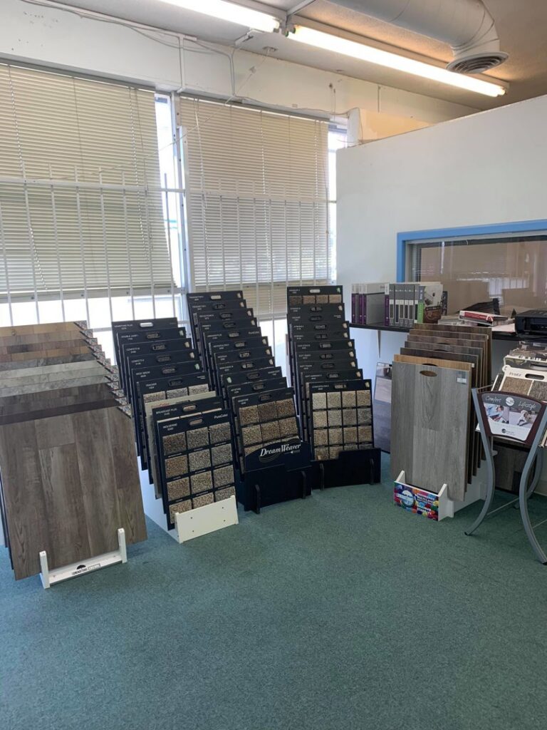 An interior view of the Rojas Carpet and Flooring showroom in Denver, CO, displaying various carpet and flooring samples for customers.