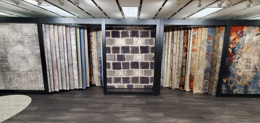 An interior view of the United Carpet showroom, showcasing various carpet and rug displays in Rochester, NY.
