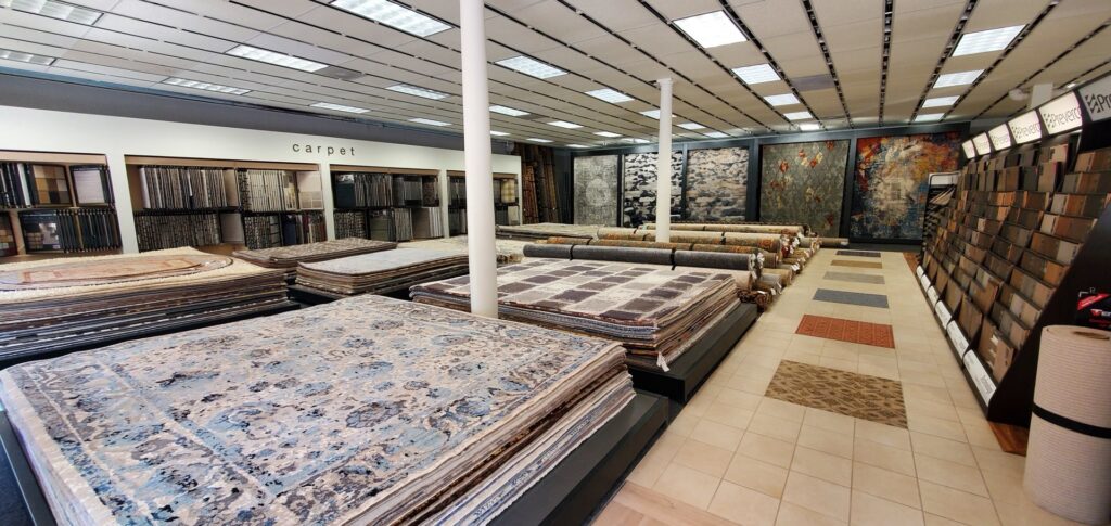 A wide view of the United Carpet showroom, displaying a large selection of carpets and rugs in Rochester, NY.