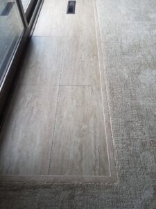 A clean transition between light-colored carpet and tile flooring installed by Great Spaces Floor Co in Minneapolis, MN.