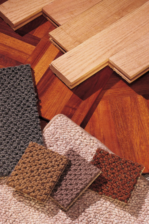 Various carpet and wood flooring samples displayed by Master Floors & More in St. Louis, MO