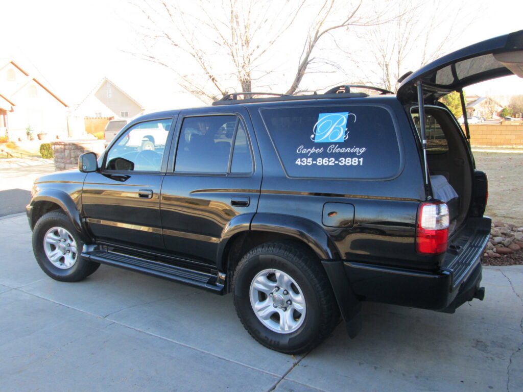 A carpeted area next to a floor protected with cardboard, indicating preparation for carpet work by B's Carpet Cleaning in Saint George, UT.