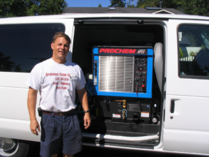 A Renaissance Carpet Care Inc technician standing proudly with their professional carpet cleaning van and equipment in Mercer Island, WA.