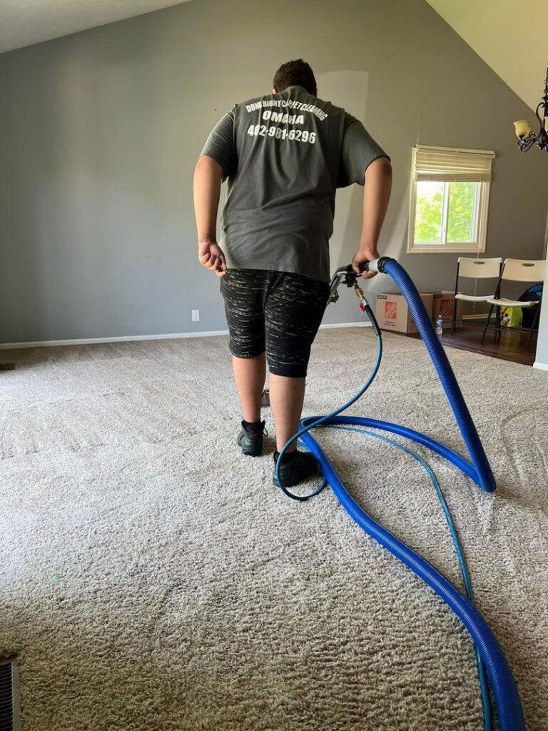 A professional carpet cleaner from Done Right Carpet Cleaning Omaha, NE, operating a cleaning machine.