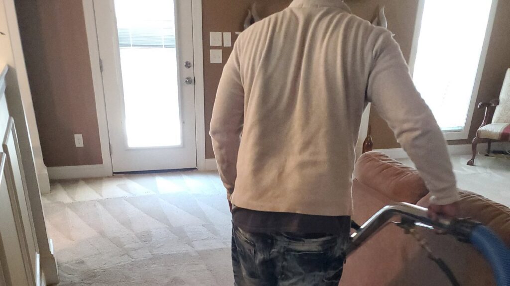 A carpet cleaner working on a residential carpet, showing clean lines, by Spot On Carpet Cleaning of Columbia, SC.