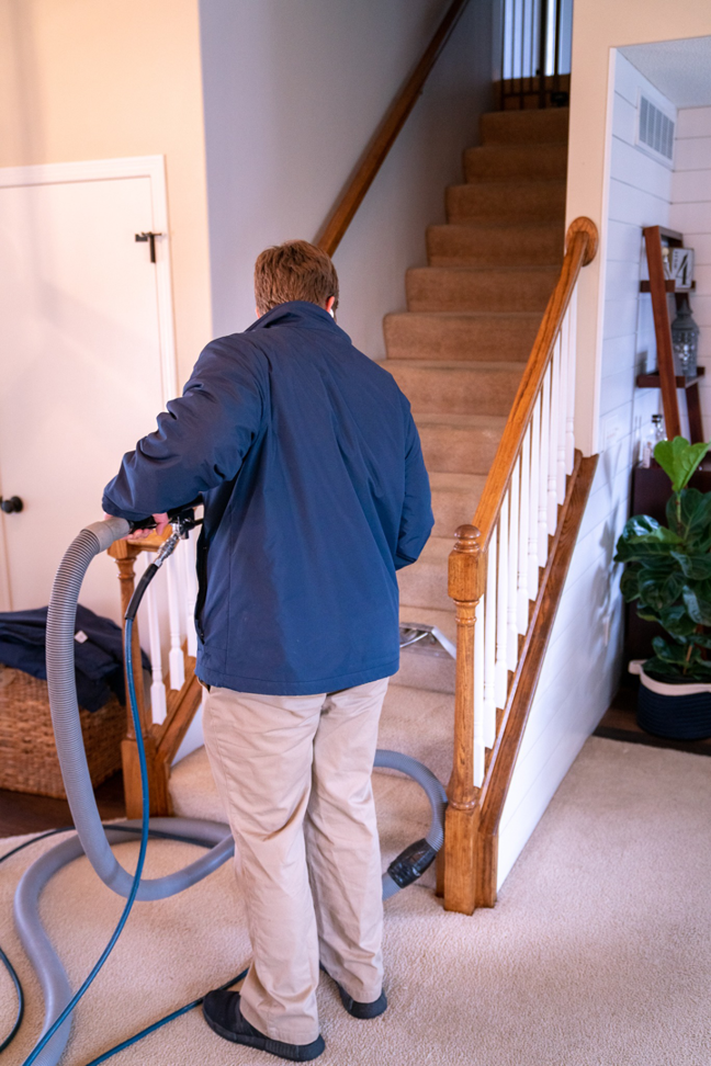 A Klein Chem-Dry technician cleaning carpeted stairs in a home in Cedar Rapids, IA.