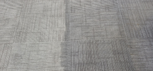 Close-up of commercial carpet tiles showing before and after cleaning by Leiter's Carpet Cleaning in Fort Wayne, IN.