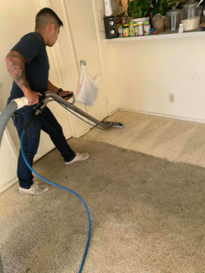 A carpet cleaning professional from Jetsupercleancarpet demonstrating before and after results in San Antonio, TX.