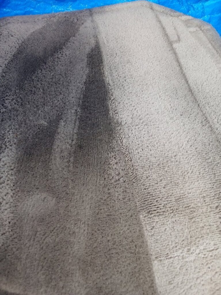 A close-up detail of carpet cleaning in progress, showing a distinct clean line on the carpet by Carpets Dirty in Phoenix, AZ