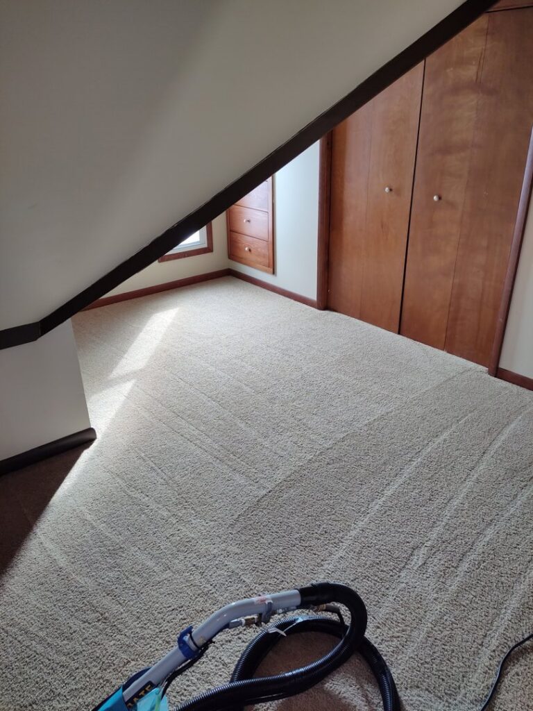 Carpet cleaning equipment with a wand and hose on a freshly cleaned carpet by 765 Custom Cleaners in Lafayette, IN.