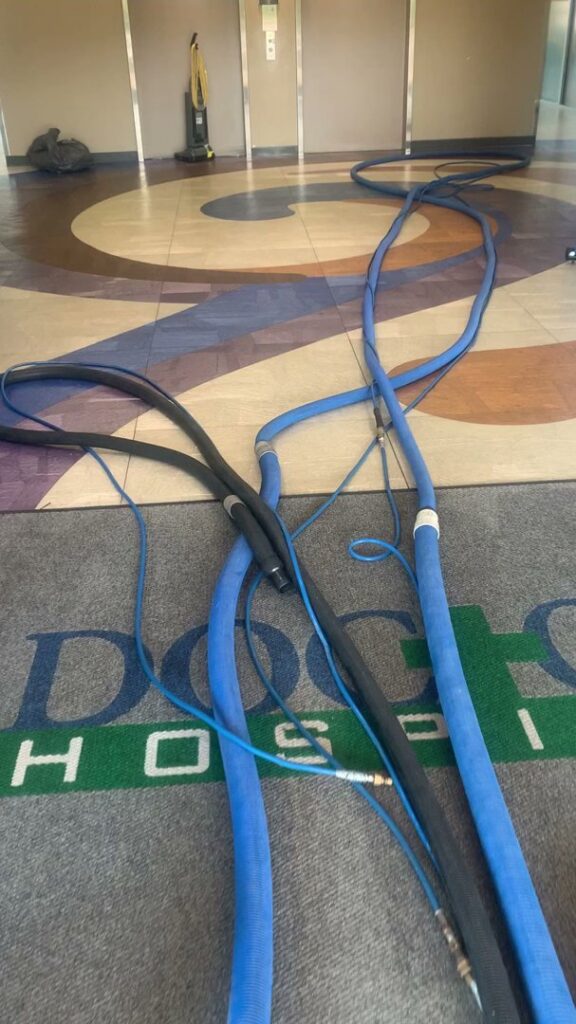 Professional carpet cleaning equipment hoses laid out across a floor, ready for a job by Superior Carpet Cleaning in Greenville, SC.