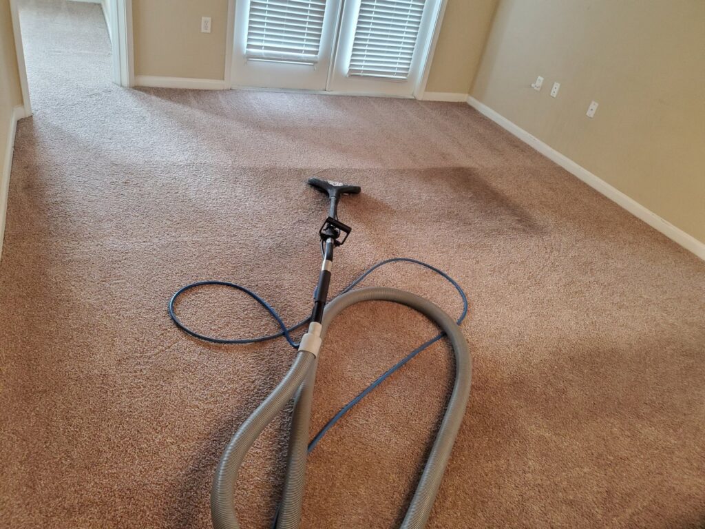 Carpet cleaning equipment and hoses on a residential carpet during a job by Tampa Steam Team in Plant City, FL.
