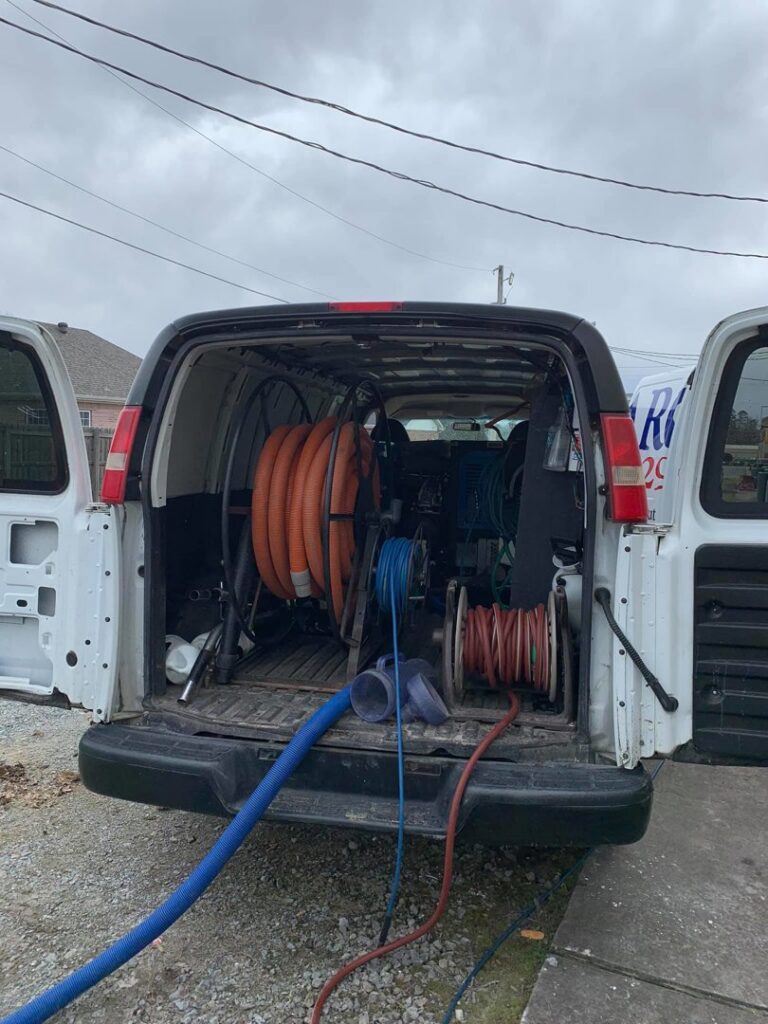 Interior view of a Promarc Carpet Care service van with hoses and cleaning equipment in Pine Bluff, AR.