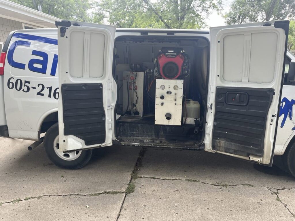 Professional carpet cleaning equipment visible inside a Carpet Master service van in Aberdeen, SD.