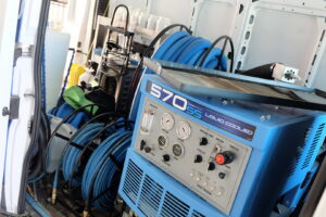 Professional carpet cleaning equipment and hoses stored inside a Christenson Cleaning & Restoration service van in Hastings, NE.