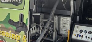 Professional carpet cleaning equipment and hoses visible inside a JDog Carpet Cleaning & Floor Care Alpharetta service van in Roswell, GA.