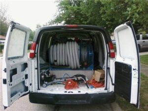 Professional carpet cleaning equipment, including hoses and machines, stored inside a service van for HutchPro Carpet Cleaning Plus in Indianapolis, IN.