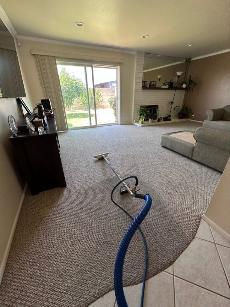 Carpet cleaning equipment, including a wand and hose, laid out on a residential carpet by Mark it Clean Carpet & Upholstery Cleaning Long Beach, CA.
