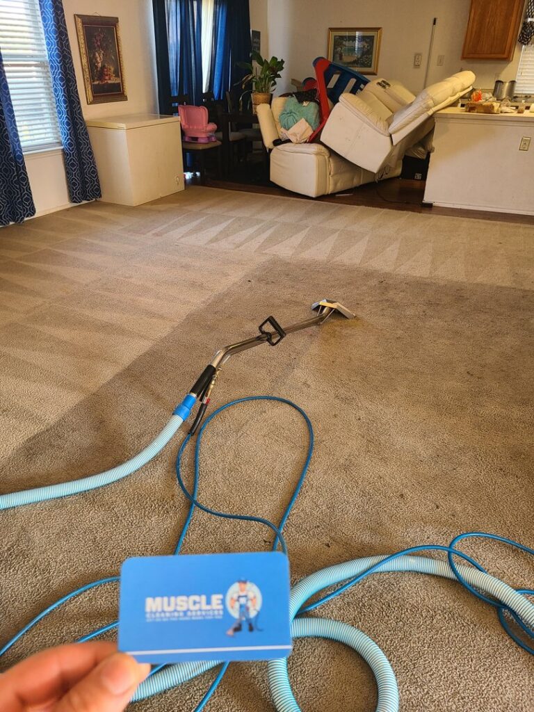 Carpet cleaning equipment and hoses on a freshly cleaned carpet, with a Muscle Cleaning Services business card in Dallas, TX.