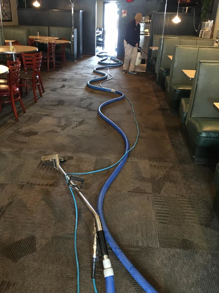 Professional carpet cleaning equipment and hoses set up in a restaurant by The Steam Master Inc. in Fort Wayne, IN.