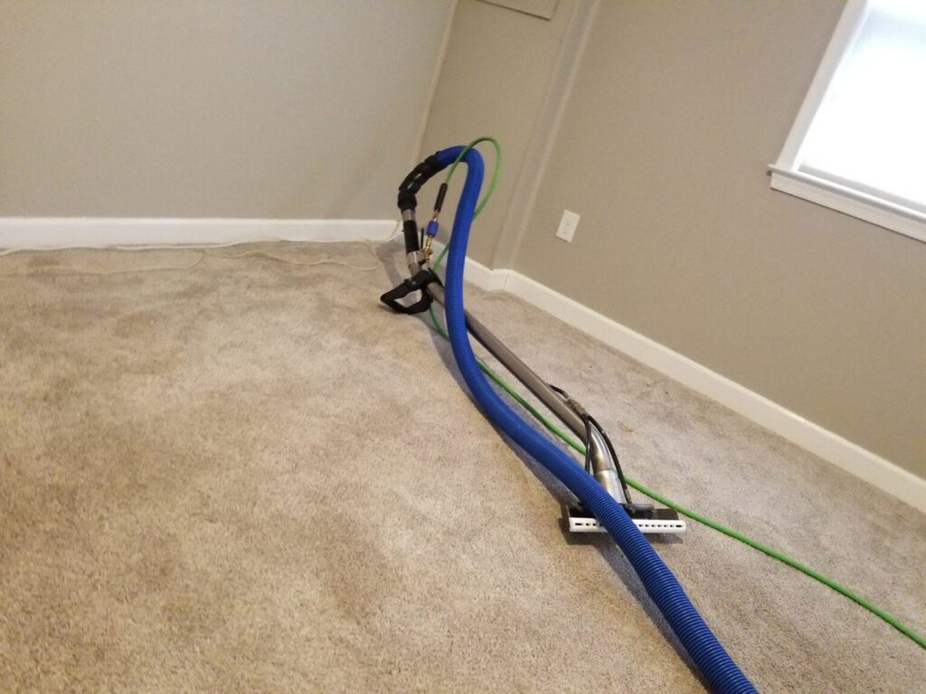 Professional carpet cleaning equipment and hoses on a carpet in a room by My Carpet Cleaning & Restoration Services in Silver Spring, MD.