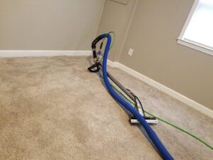 Professional carpet cleaning equipment and hoses on a carpet in a room by My Carpet Cleaning & Restoration Services in Silver Spring, MD.