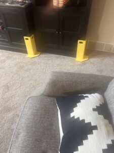 Carpet cleaning hoses, chemicals, and equipment set up for a job by Green Bay Carpet Cleaning in Green Bay, WI.