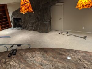 Carpet cleaning equipment and hoses set up on a light-colored carpet by North Seattle Carpet Cleaning in Seattle, WA