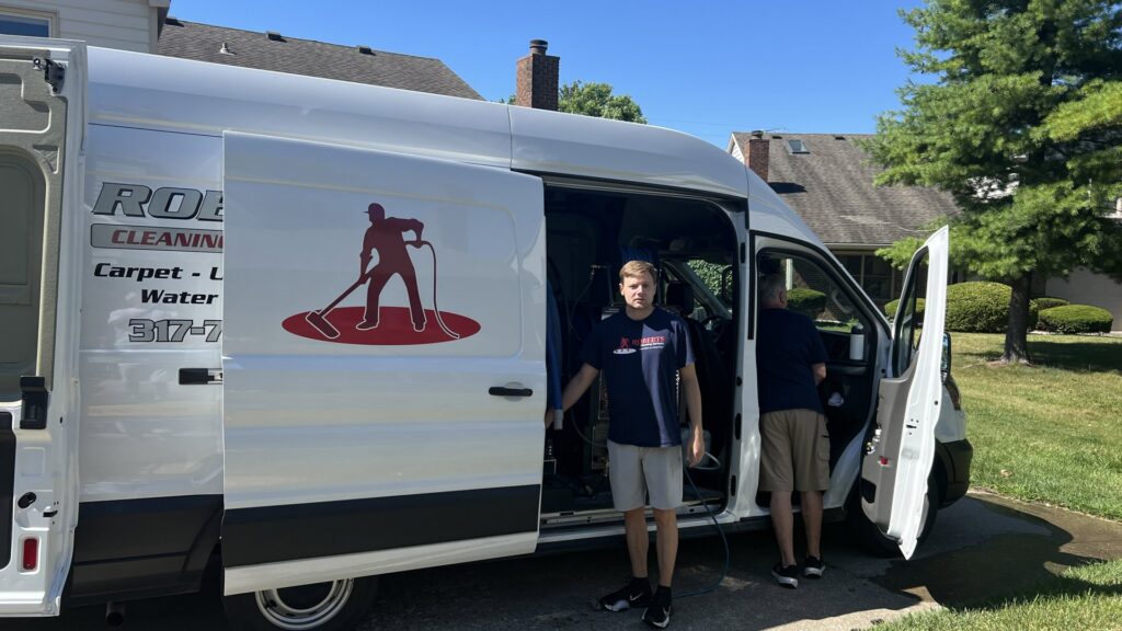 Carpet cleaning equipment being set up from a Roberts Cleaning Services van in Zionsville, IN.