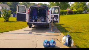 Professional carpet cleaning equipment set up from a branded van by True Organic Carpet Cleaning in Charlotte, NC.
