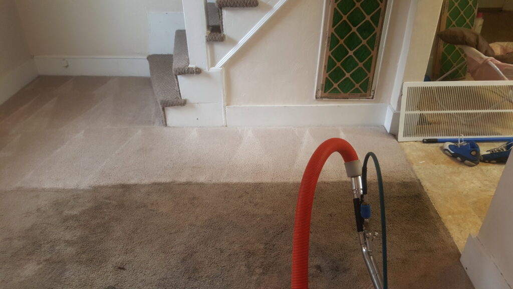 Carpet cleaning equipment on a floor leading to stairs, showing work in progress by American Steam in Suffolk, VA.