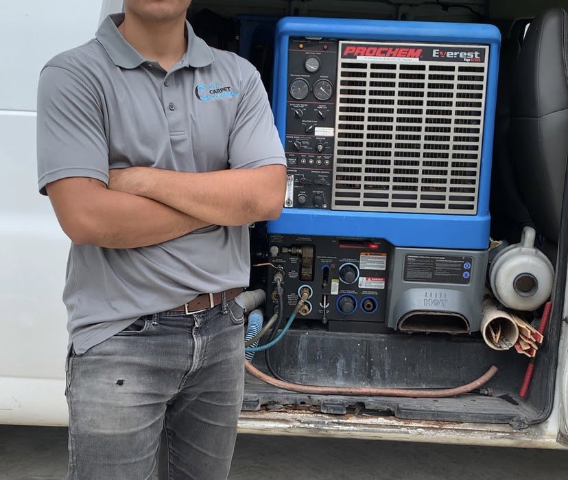 A technician standing next to professional carpet cleaning equipment in a van from City Carpet Cleaners 1 in Houston, TX
