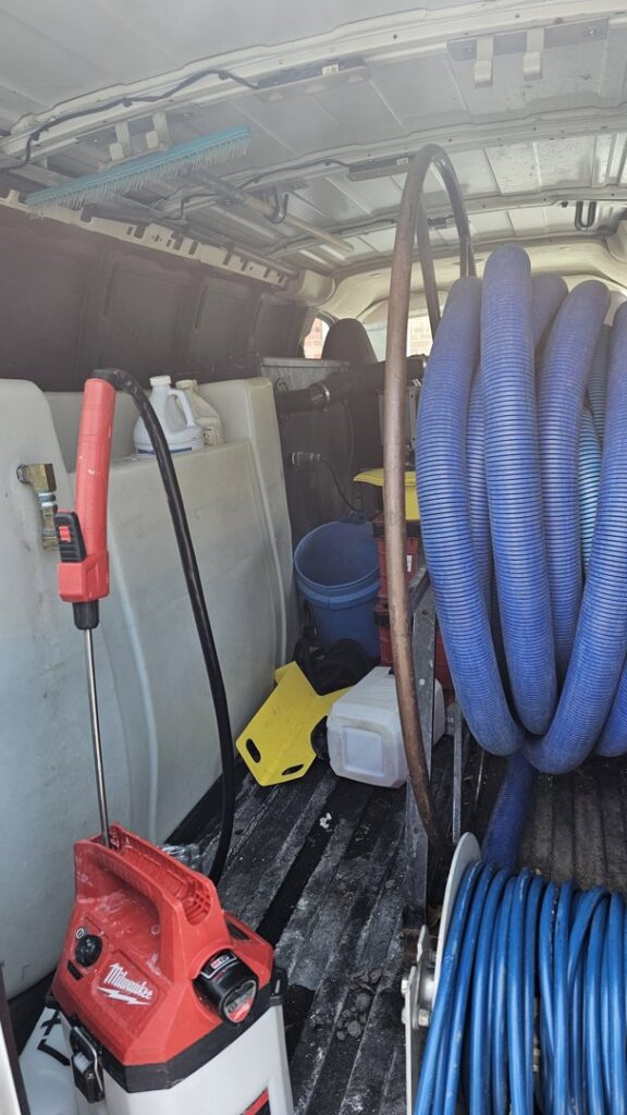 Interior view of a Columbia Carpet Cleaning van, showing professional carpet cleaning equipment and hoses in Columbia, MO.