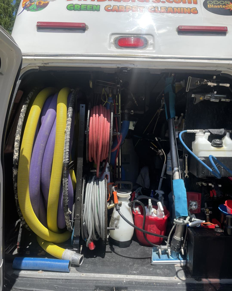 Carpet cleaning equipment and hoses stored in a Dirt Blasters Carpet Cleaning Inc. van in Atlanta, GA