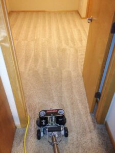 A white service van with professional carpet cleaning equipment, including a Rotovac machine, from DW Facility Services LLC in Brooklyn Center, MN