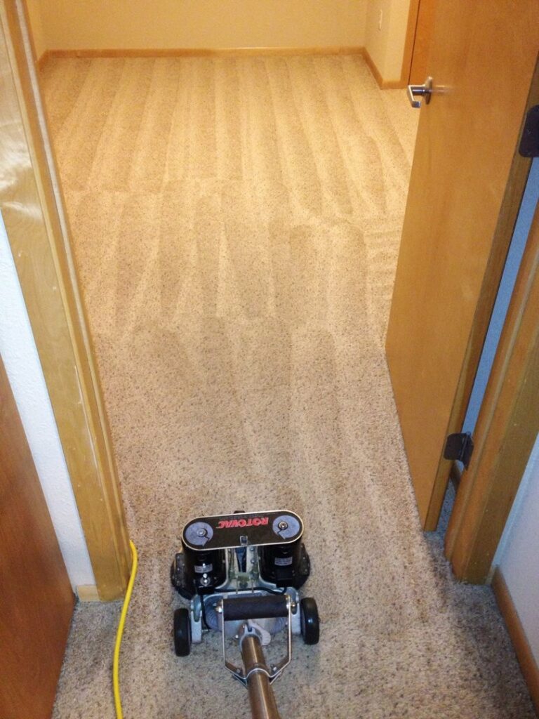 A white service van with professional carpet cleaning equipment, including a Rotovac machine, from DW Facility Services LLC in Brooklyn Center, MN
